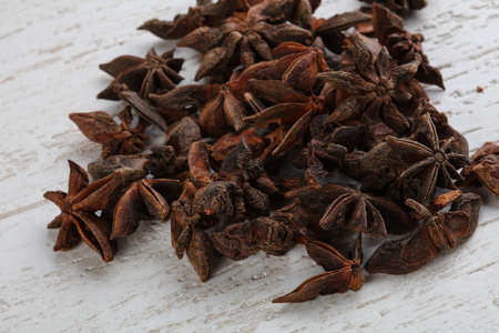 Star-anise seeds heap on the wood background