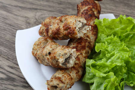 Meat kebab with green salad leavesの写真素材