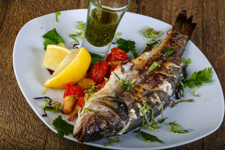 Grilled seabass fith with lemon, tomato and thyme sauceの写真素材