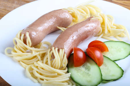 Kids style spaghetti with sausages and cucumberの写真素材