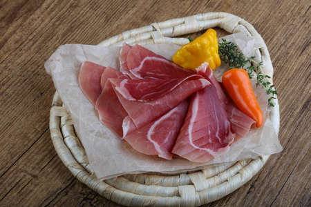 Spanish Jamon curado with thyme branch on woodの写真素材