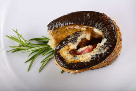 Stuffed eggplant with tomato and rosemary branchの写真素材