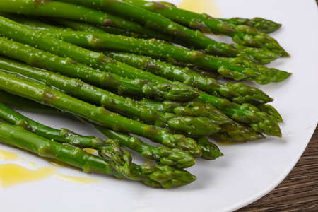 Boiled asparagus with olive oil on  the white plateの写真素材