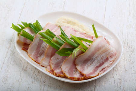 Ham with onion on the white plateの写真素材
