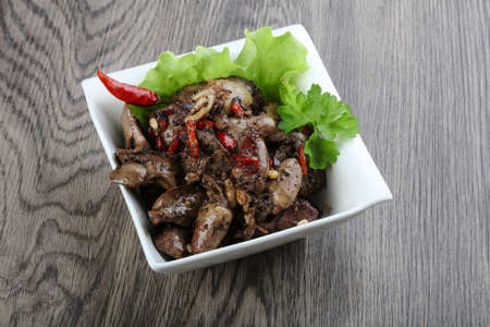 Baked chicken hearts and liver with pepperの写真素材