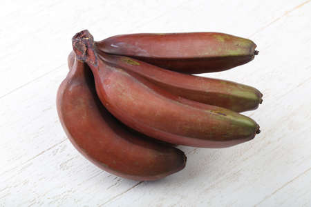 Red banana heap on the wood backgroundの写真素材