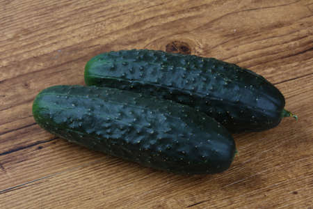 Two Green cucumbers on the wood backgroundの写真素材
