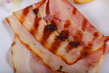 Grilled bacon with potato, onion and tomatoの写真素材