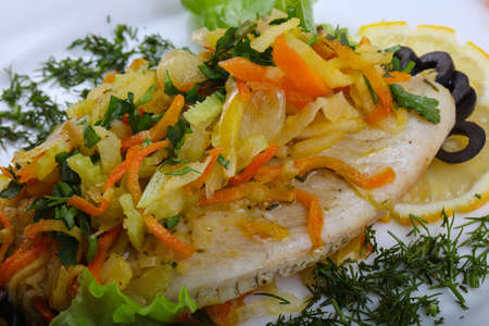 Baked tilapia with vegetables - carrot, onion and olives