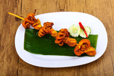 Asian octopus skewer on banana leave with pepperの写真素材