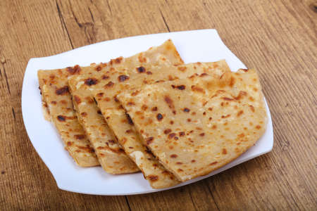 Indian bread roti on the plate in wood backgroundの写真素材