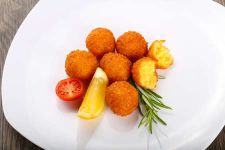 Hot juicy Cheese balls served rosemary branchの写真素材