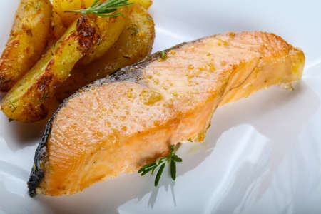 Baked salmon with potato and rosemaryの写真素材