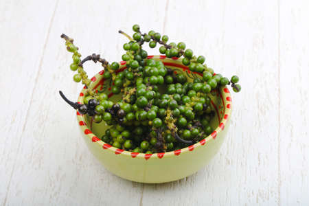 Green pepper corn on the branch in plateの写真素材