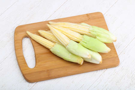 Fresh baby corn heap on the wood backgroundの写真素材