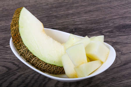Sweet sliced melon on wood backgroundの写真素材