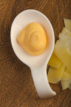 Cheese sauce with sliced parmesan and basil leaves