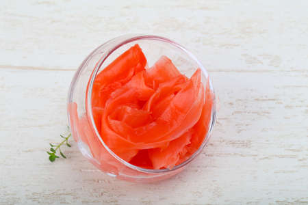 Pickled ginger in the bowl on wood backgroundの写真素材