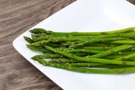 Boiled asparagus with olive oil on  the white plateの写真素材