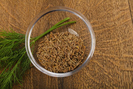 Cumin seeds heap on the wood backgroundの写真素材