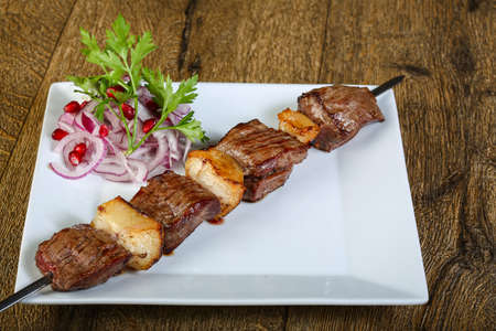 Hot juicy Lamb skewer on the white plateの写真素材