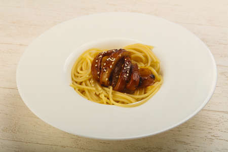Pasta with teriyaki squid served sesame seedsの写真素材