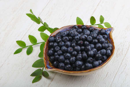 Blueberry heap with leaves in the bowlの写真素材