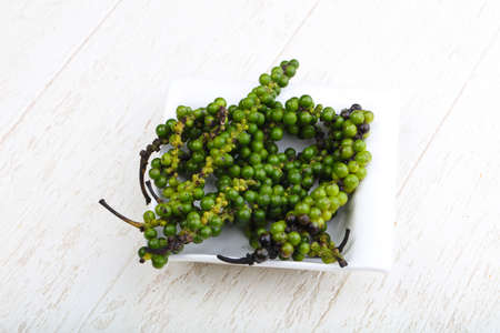 Green pepper corn on the branch in plateの写真素材