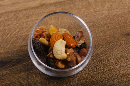 Nut mix heap in the bowl over wood backgroundの写真素材