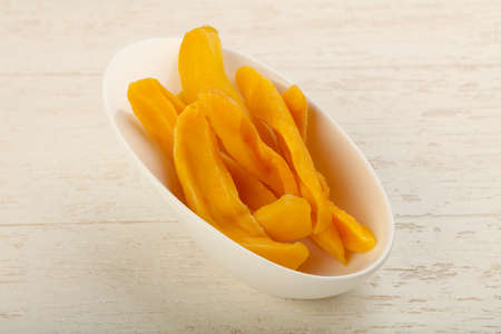 Dry mango chips heap in the bowlの写真素材