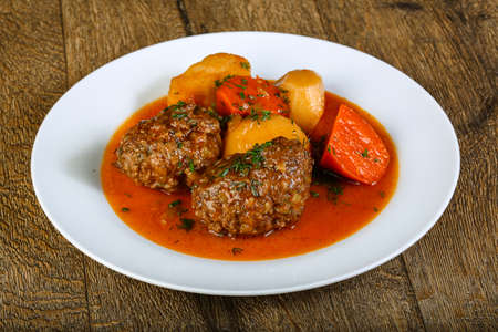 Minced meat balls with potato, carrots and sauceの写真素材