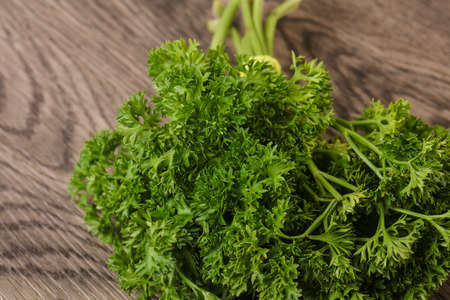 Fresh green parsley heap over the wooden backgroundの写真素材