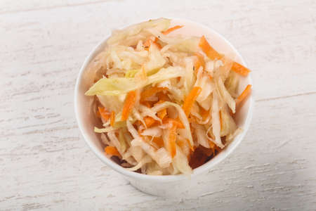 Raw pickled cabbage on wood backgroundの写真素材
