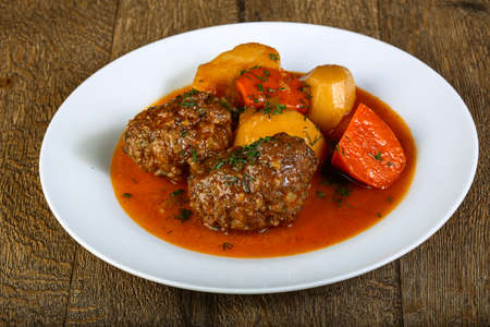 Minced meat balls with potato, carrots and sauceの写真素材