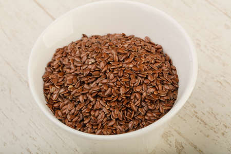Fry Flax seeds heap in the bowl over wooden backgroundの写真素材