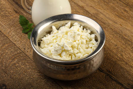 Cottage cheese in the bowl with milkの写真素材