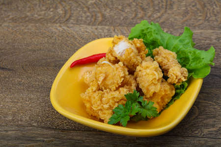 Crispy chicken nuggets with spices on wood backgroundの写真素材