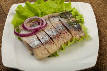 Sliced Herring fillet with dill and onionの写真素材