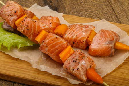 Raw salmon skewer with spices ready for cookingの写真素材