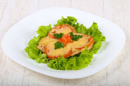 Pork baked with tomato and cheese served parsleyの写真素材