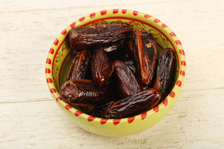 Sweet dates fruit heap in the bowl