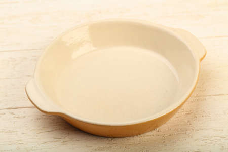 Empty plate for home or restorant over wooden background