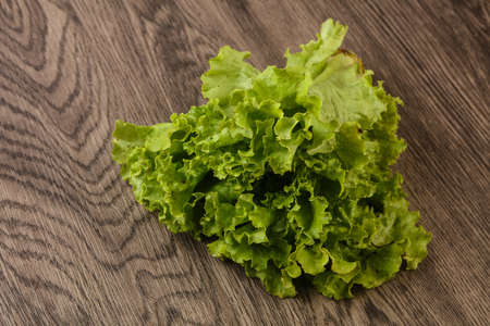 Fresh green Salad leaves over the wooden backgroundの写真素材