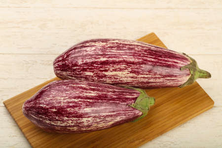 Fresh ripe eggplant over the wooden backgroundの写真素材