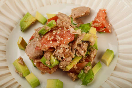 Tuna and avocado salad with tomato served sesame seedsの写真素材