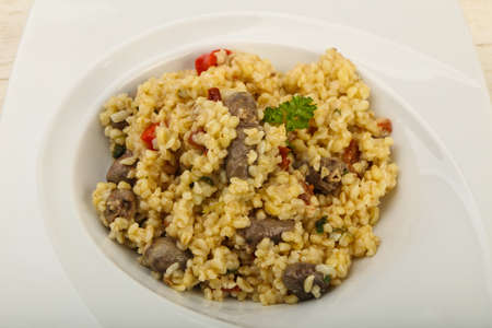 Bulgur with chicken hearts and dry tomatoesの写真素材