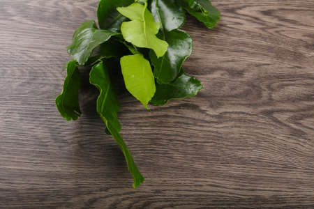 Kafir lime leaves on the wood backgroundの写真素材