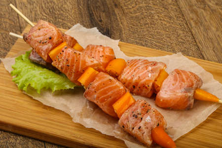 Raw salmon skewer with spices ready for cookingの写真素材