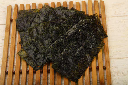 Crispy Nori sheets chips over wooden background