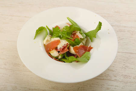 Salad with proscuitto, mozzarella, rucola and olive oilの写真素材
